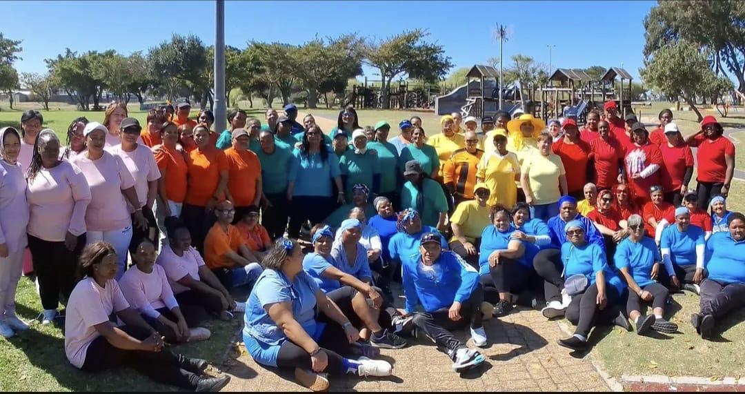 IPI care workers and community members gathered in colour-coded teams at a community wellness day in Cape Town