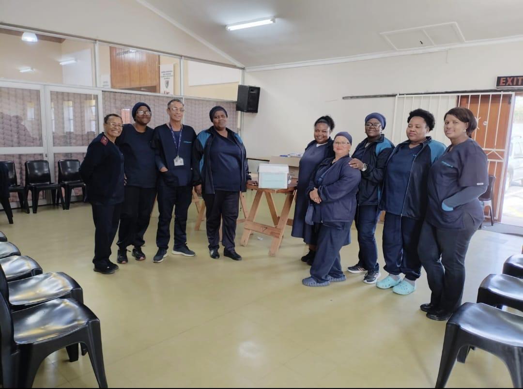 The IPI home-based care team in uniform at a community hall outreach point in Athlone, Cape Town